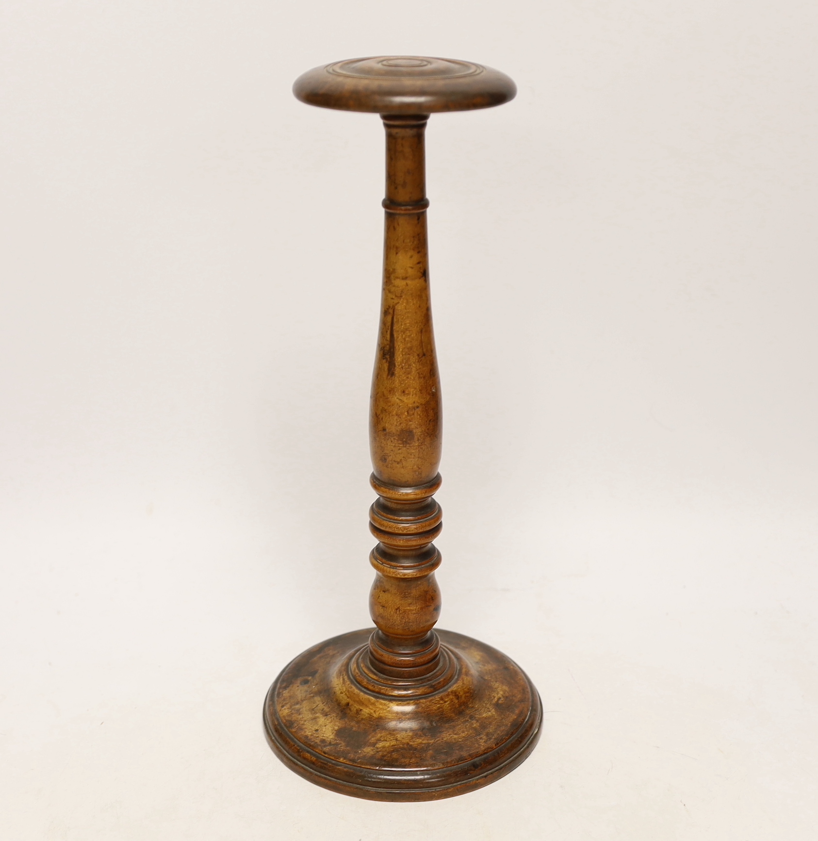 A turned maple wig stand ‘Made from the beam of the Victory of which Lord Nelson died’, 30cm